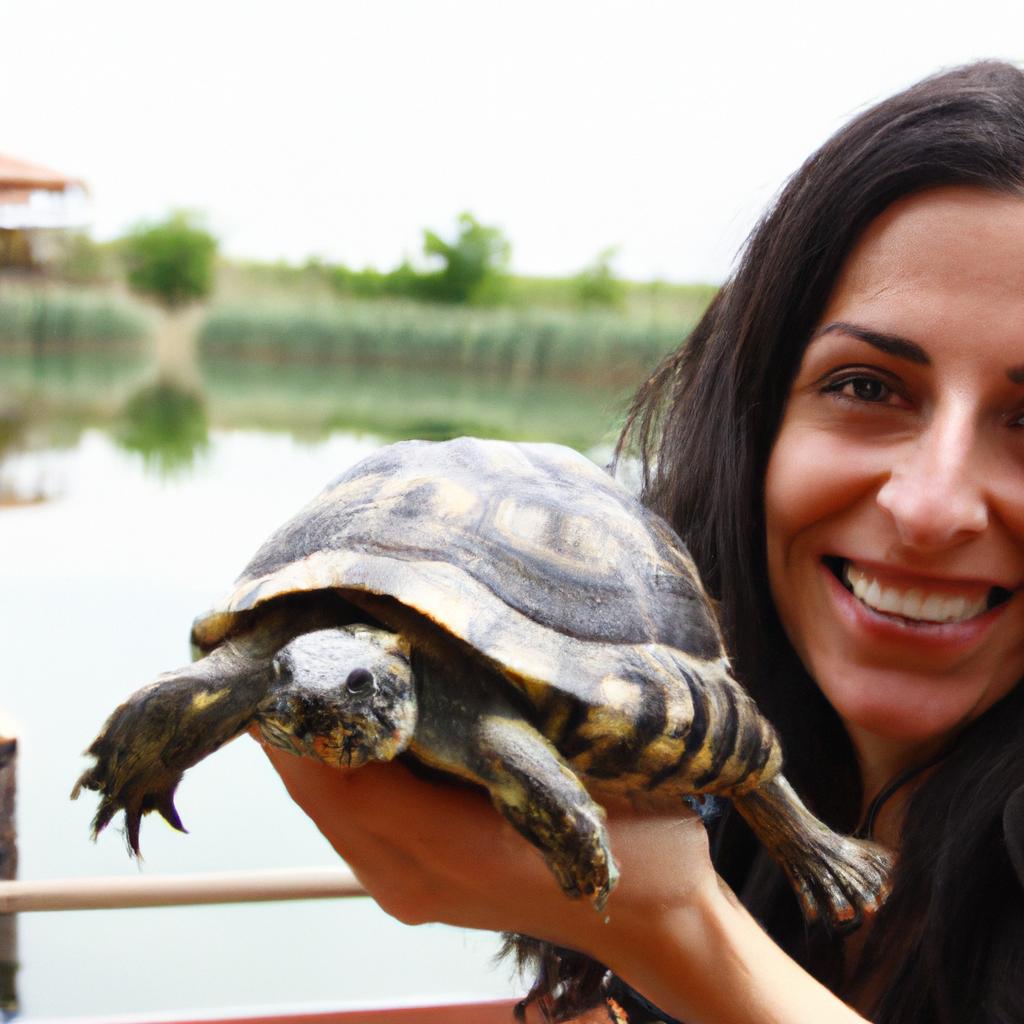 Woman holding a turtle, smiling